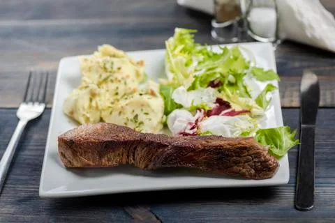 Beef steak with mashed potatoes and rocket salad Stock Photos