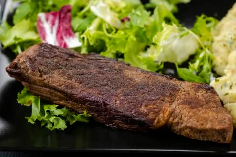 Beef steak with mashed potatoes and rocket salad Stock Photos