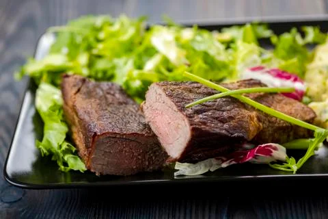 Beef steak with mashed potatoes and rocket salad Stock Photos