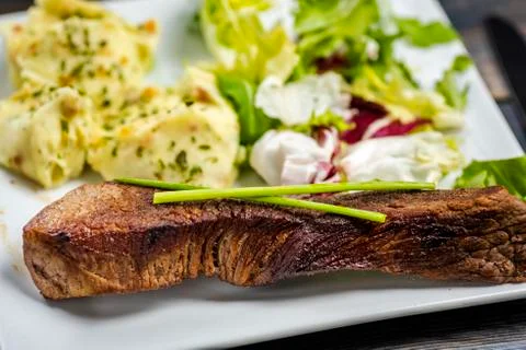Beef steak with mashed potatoes and rocket salad Stock Photos