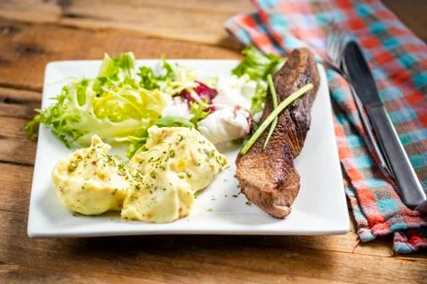 Beef steak with mashed potatoes and rocket salad Stock Photos