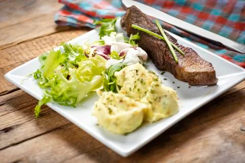 Beef steak with mashed potatoes and rocket salad Stock Photos
