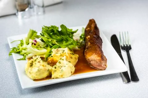 Beef steak with mashed potatoes and rocket salad Stock Photos