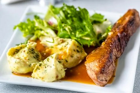 Beef steak with mashed potatoes and rocket salad Stock Photos