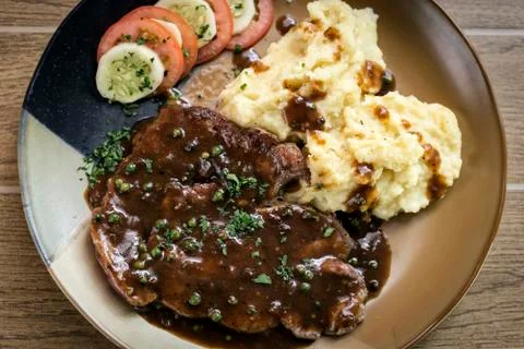 Beef steak meal with mashed potato and gravy sauce Stock Photos
