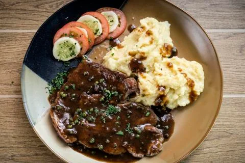 Beef steak meal with mashed potato and gravy sauce Stock-Fotos