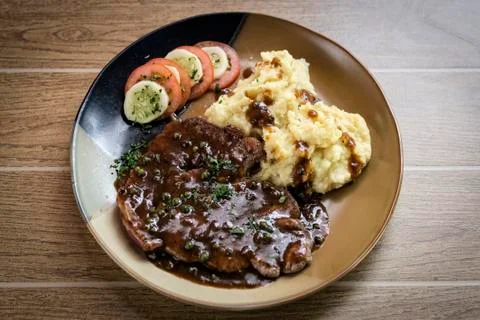 Beef steak meal with mashed potato and gravy sauce Stock Photos