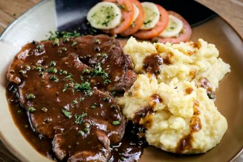 Beef steak meal with mashed potato and gravy sauce Stock Photos