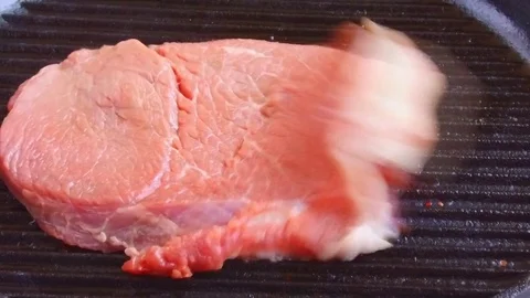 Beef steak meat falls on a grill pan Stock Footage 77303239