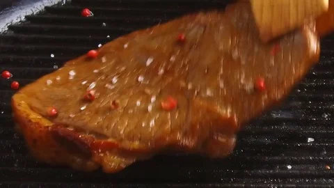 Beef steak meat on a grill pan inverted preparation Stock Footage 77338835