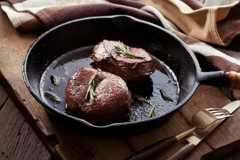 Beef steak in pan Stock Photos