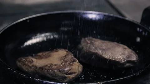 Beef steak on a pan plate sprinkled with coarse salt Stock Footage 146947713