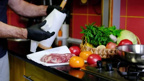 Beef steak patted dry with paper towel by chef before cooking to remove surface Stock Footage 346182694