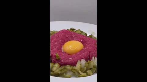 Beef steak tartare topped with a raw egg yolk Stock Footage 321187443