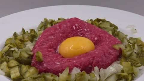 Beef steak tartare topped with a raw egg yolk Stock Footage 321187545