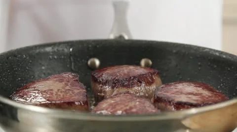 Beef steaks being fried in a pan Stock Footage 24648090