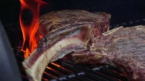 Beef steaks on the grill with flames Video stock 250157971