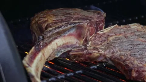 Beef steaks on the grill with flames Video stock 250157974