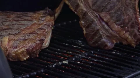 Beef steaks on the grill with flames Video stock 250157977