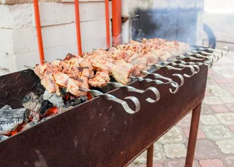 Beef steaks on the grill with flames 库存照片