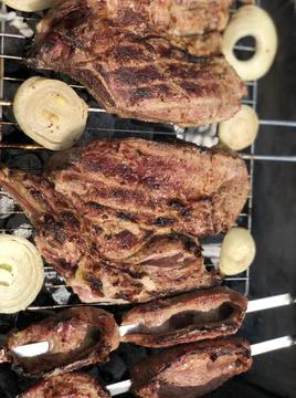 Beef steaks on the grill with flames Stock Photos
