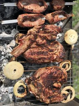 Beef steaks on the grill with flames Stock Photos
