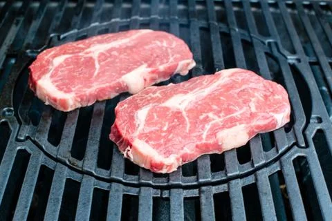 Beef steaks on the grill Stock Photos