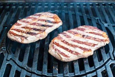 Beef steaks on the grill Stock Photos