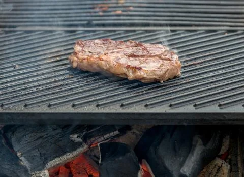 Beef steaks on the grill Stock Photos