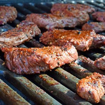 Beef steaks on the grill Stock Photos