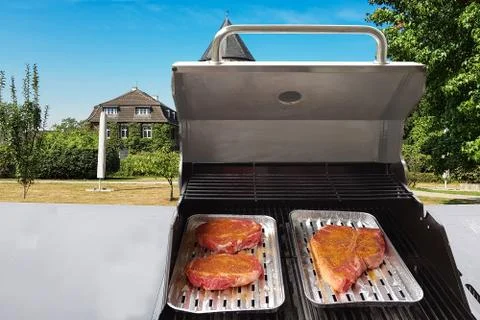 Beef steaks on the grill Stock Photos