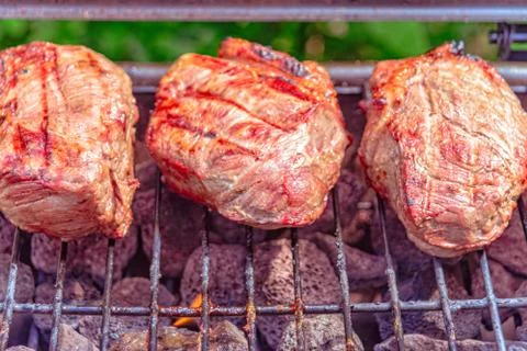 Beef steaks on the grill Stock Photos