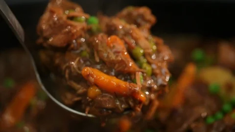 Beef stew. Spoon scooping through meat and veggies. CU Stock Footage 102135270