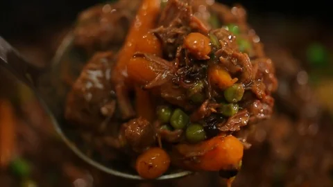 Beef stew. Spoon scooping through meat and veggies. Super CU Stock Footage 102135273