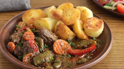 Beef stew with vegetables and fried potatoes cooking process Video stock 90422772