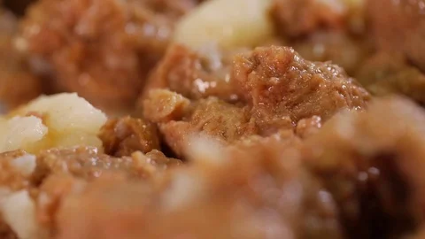 Beef stew on a white plate, canned product Stock Footage 75471897