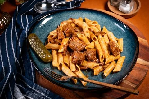 Beef stewed with penne. Stock Photos