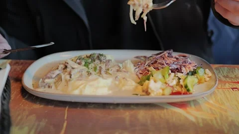 Beef Stroganoff With Mashed Potatoes and Fresh Salad Served in Cozy Restaurant Stock Footage 340820936