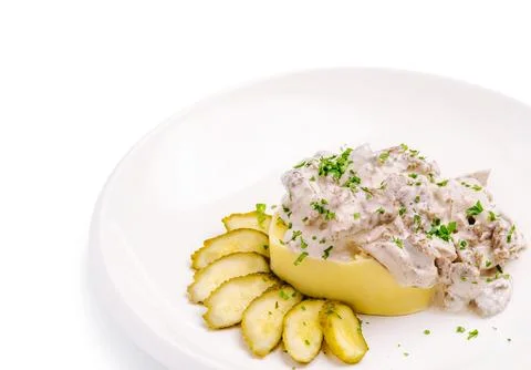 Beef stroganoff with mashed potatoes and sliced pickles Stock Photos