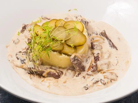 Beef stroganoff with mashed potatoes on a white plate Stock Photos