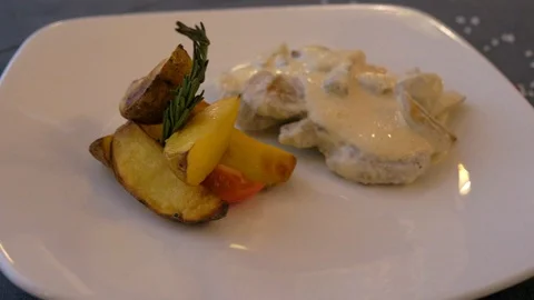 Beef stroganoff in sauce with potatoes on the white plate. Stock Footage 104057494