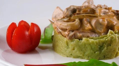 Beef stroganoff, served on a Pesto mashed potato, decorated with cherry tomatoes Stock Footage 87326533