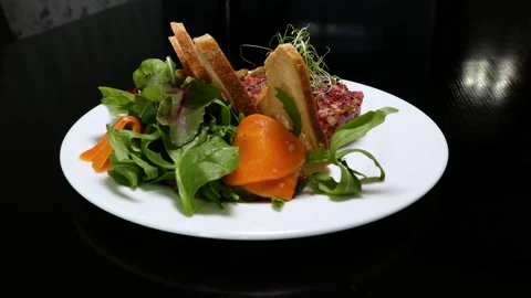 Beef tartar with capers. Beef tartar with slices of bread. Stock Footage 133548488