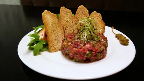 Beef tartar with capers. Raw meat tartare for gourmet meat. 스톡 동영상 245610360