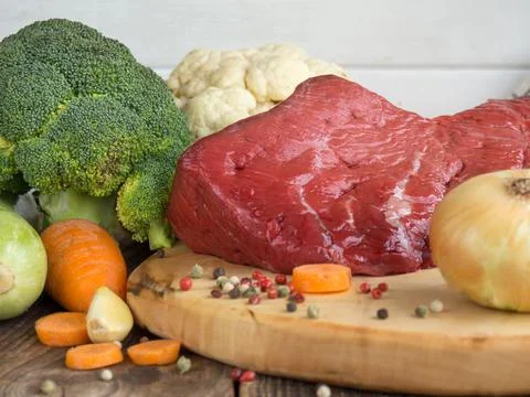 Beef tenderloin and vegetables on rustic wooden background Stock Photos
