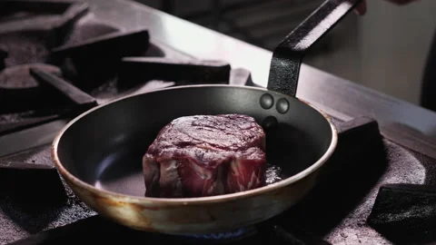 Beef tenderloin steak fried in small frying pan - close-up Video stock 154365905