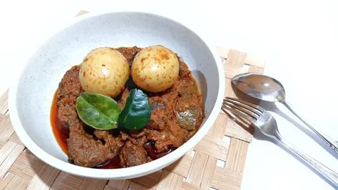 Beef Toppa Lada with eggs served in a white bowl Stock Photos
