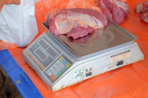 Beef was weighed before being distributed to the poor muslims in needs during Stock Photos