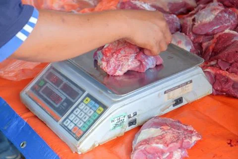 Beef was weighed before being distributed to the poor muslims in needs during Stock Photos