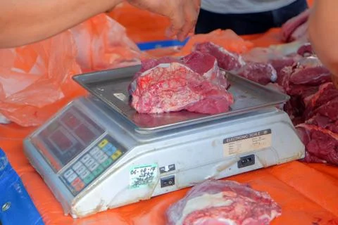 Beef was weighed before being distributed to the poor muslims in needs during Stock Photos